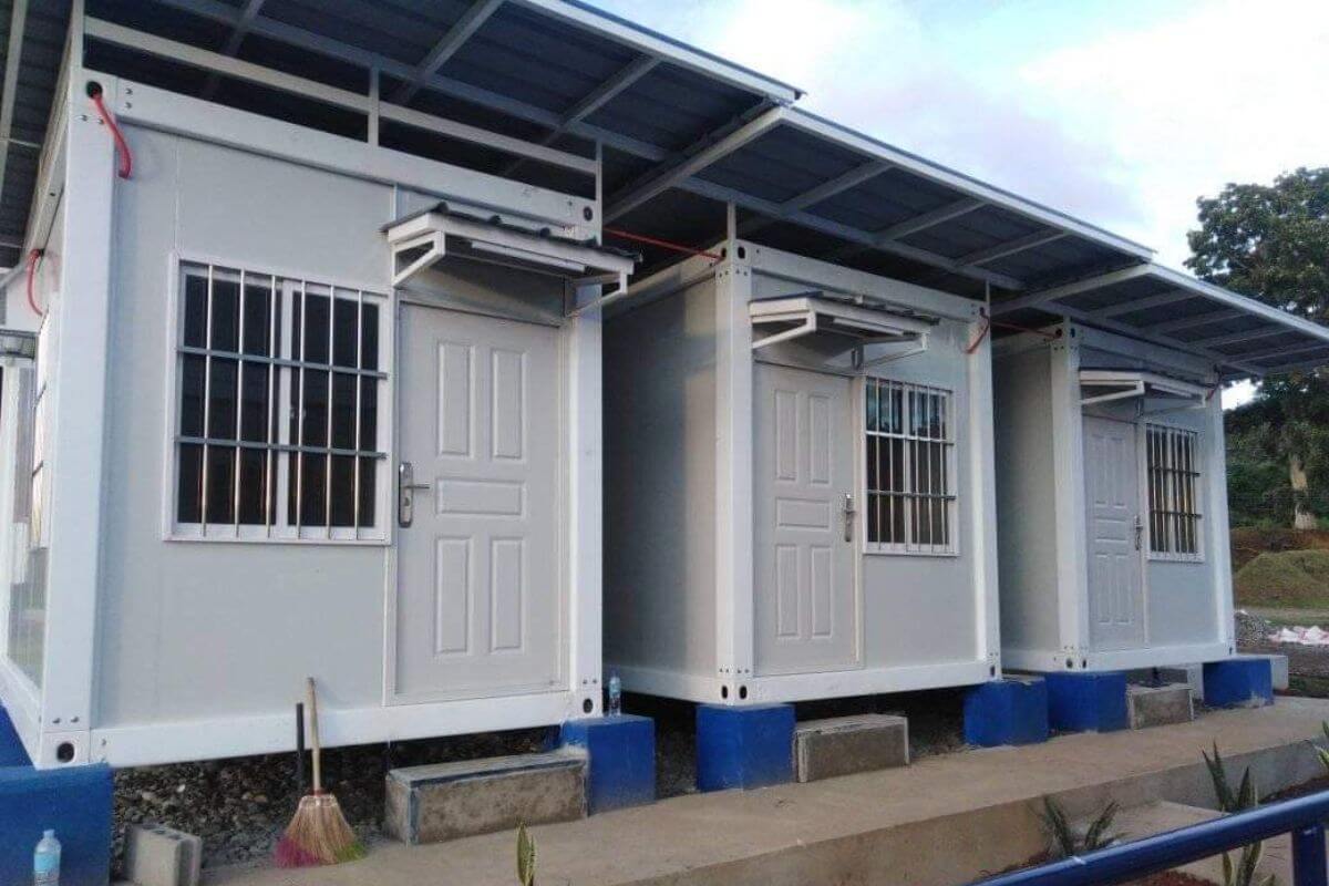 a row of white prefab rental apartment