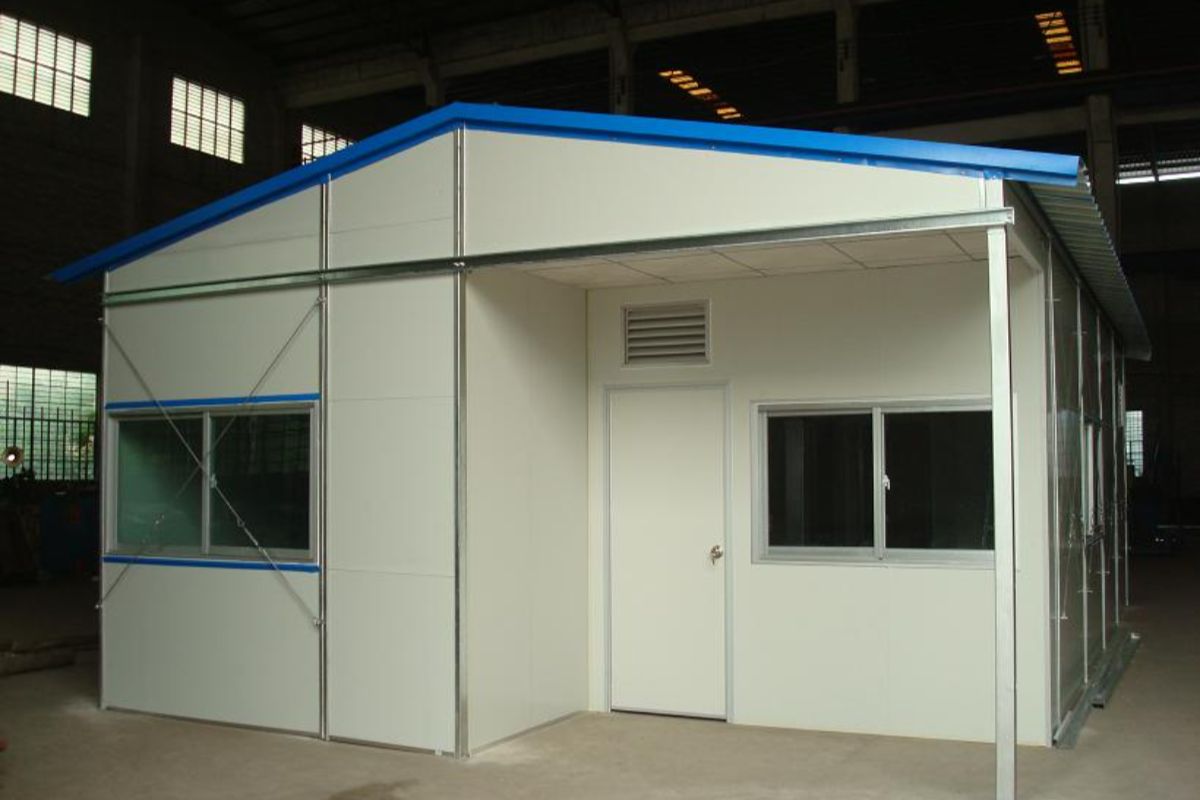 Compact prefab retail building with blue roof and front windows