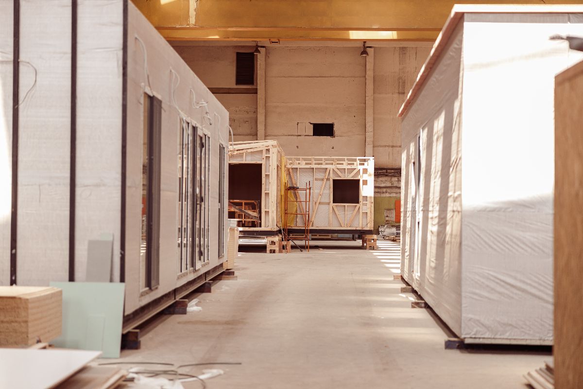 Prefab container units being assembled inside a production facility