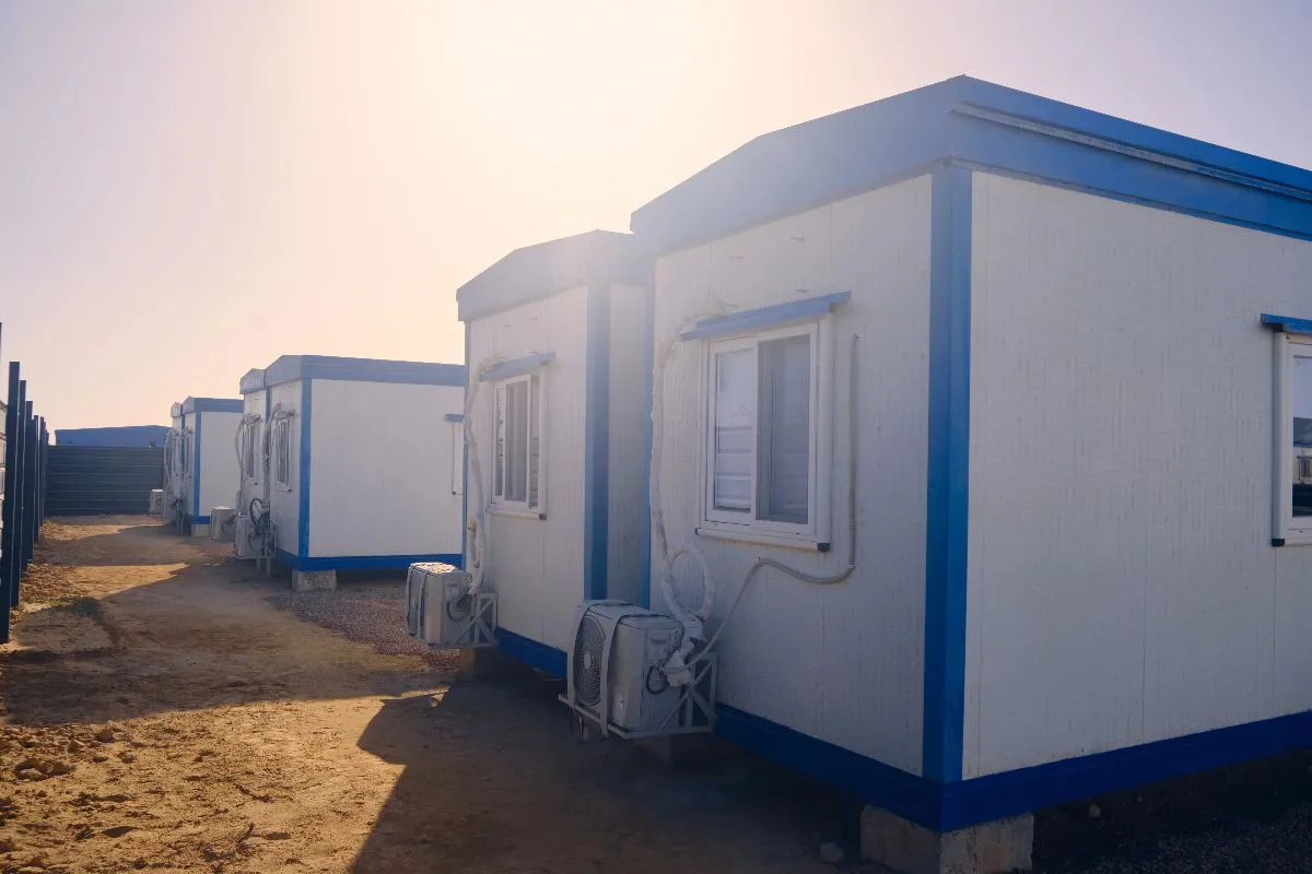 Prefab site building with exterior staircase and white modular panels for construction and industrial workspaces