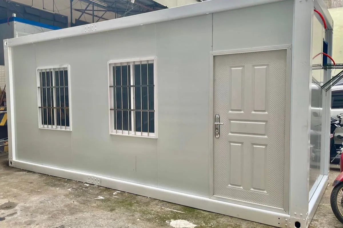 Single-story prefab home with two windows, a front door, and a compact modular design