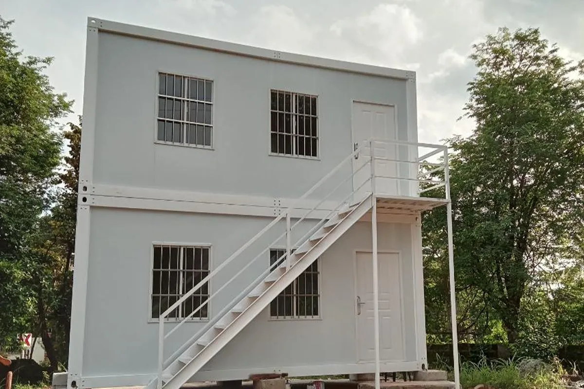 Two-story prefab rental unit with exterior staircase, windows, and separate upper and lower entrances